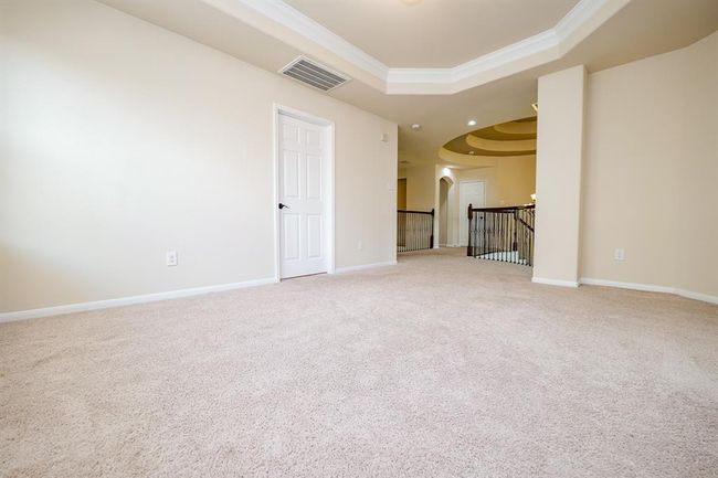 Here, on the 2nd 'game room' floor, is tremendous open space for a casual 2nd living retreat, and/or a true gamer's paradise, with soft wall and carpet tones, intimate tray ceiling above, and easy access to the staircase and bedrooms. | Image 15