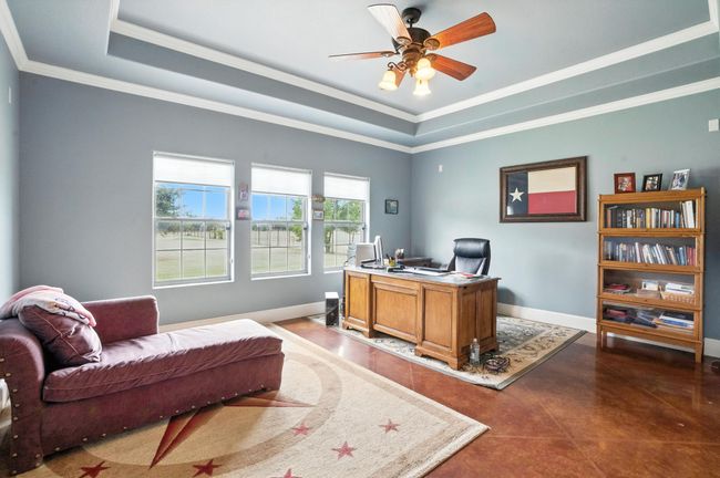 Office featuring crown molding, a raised ceiling, and a ceiling fan | Image 21