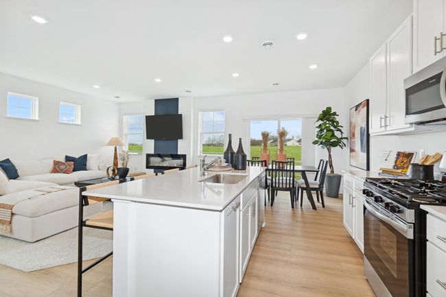 (Photo of decorated model, actual home's finishes will vary) An open layout flows from the Kitchen to the dining room to the great room with ease. | Image 5