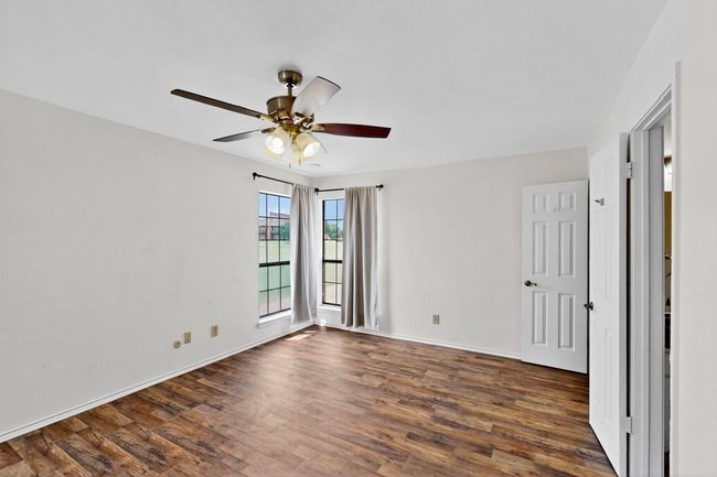 Spare room featuring dark wood finished floors, a ceiling fan, and baseboards | Image 22
