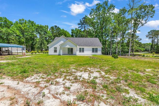 View of front facade with a front lawn and view of wooded area | Image 36