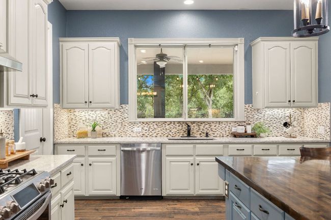 Doing dishes isn't too bad with a view of the pool and back side of the property. | Image 9