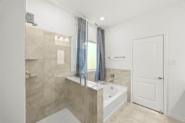 Bathroom featuring a bath, a shower stall, and tile patterned flooring | Image 24