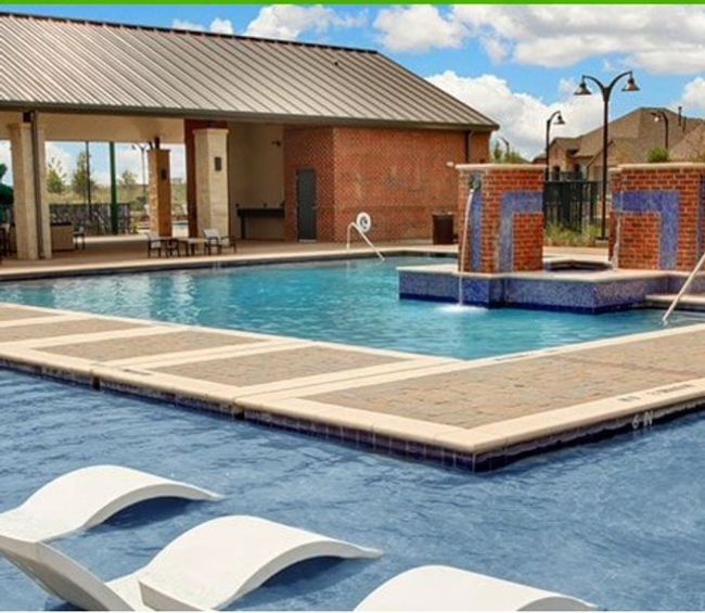 Community pool with a patio and fence | Image 36