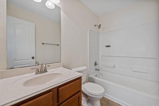 Upstairs full bath with tub/shower combo and large vanity. | Image 9