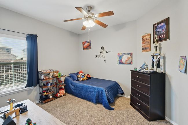 Carpeted bedroom with ceiling fan and baseboards | Image 28