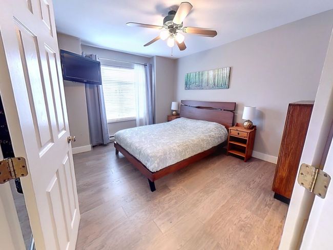 Bedroom featuring a ceiling fan, baseboards, and light wood-style floors | Image 11