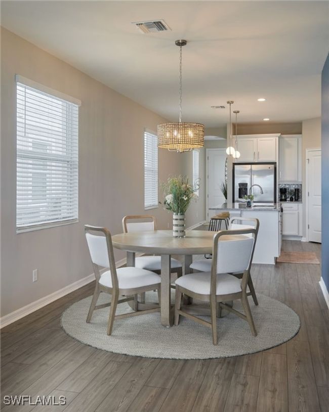 Dining area featuring dark wood-style floors, recessed lighting, visible vents, a chandelier, and baseboards | Image 8