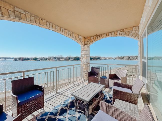 View of patio with a water view and a balcony | Image 25