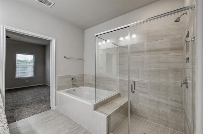 Glass-enclosed shower and large bathtub | Image 17