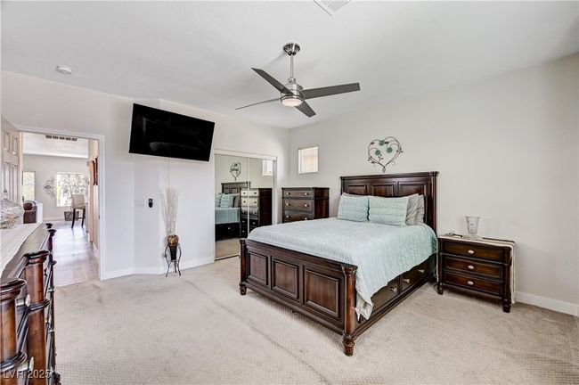 Bedroom with light colored carpet, a closet, and ceiling fan | Image 16
