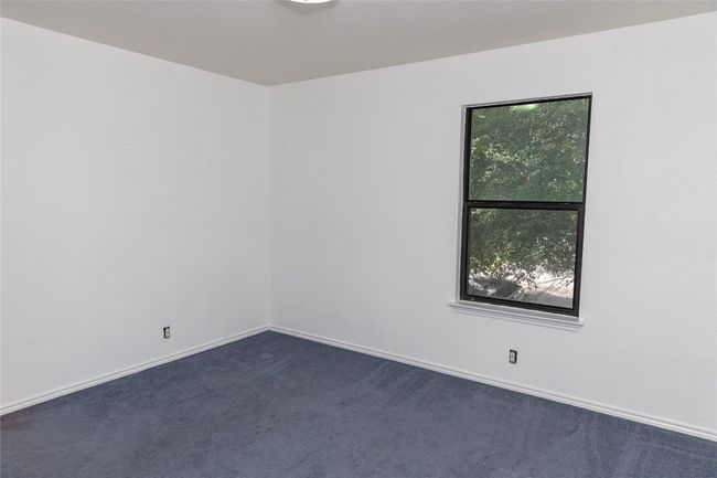 Spare room with dark carpet and baseboards | Image 14