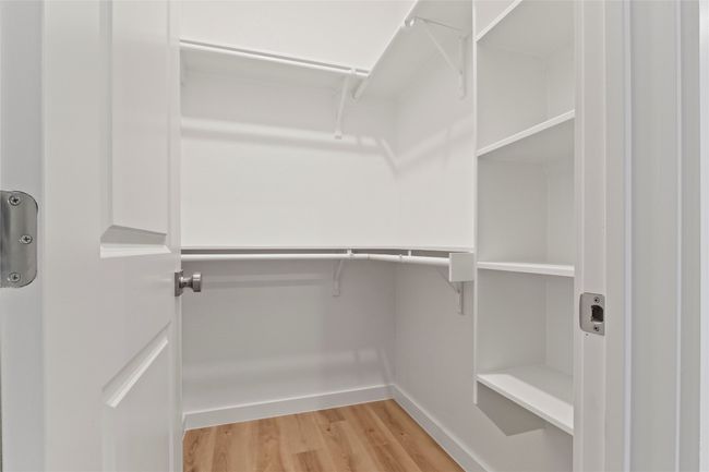 A modern, spacious primary closet with ample storage and sleek shelving—perfect for effortless organization | Image 19