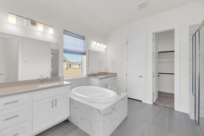 Full bathroom with a stall shower, a sink, and visible vents | Image 21