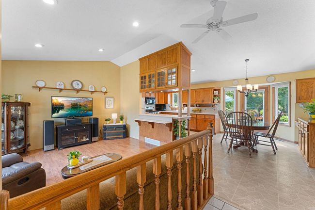 Enter into the open concept, vaulted ceiling main floor drenched with natural light. | Image 5
