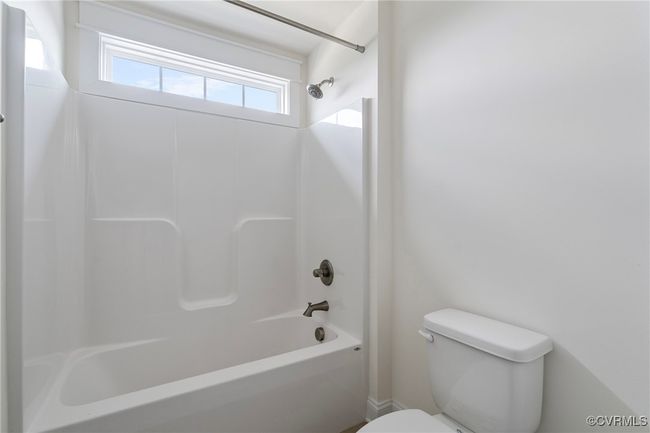 Bathroom featuring toilet and shower / bathtub combination | Image 34