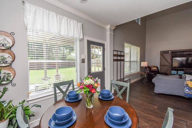 On the way outside, notice the door to your backyard is conveniently placed in the center of the entertaining areas and easily accessible from your living room, breakfast room, and kitchen. | Image 28