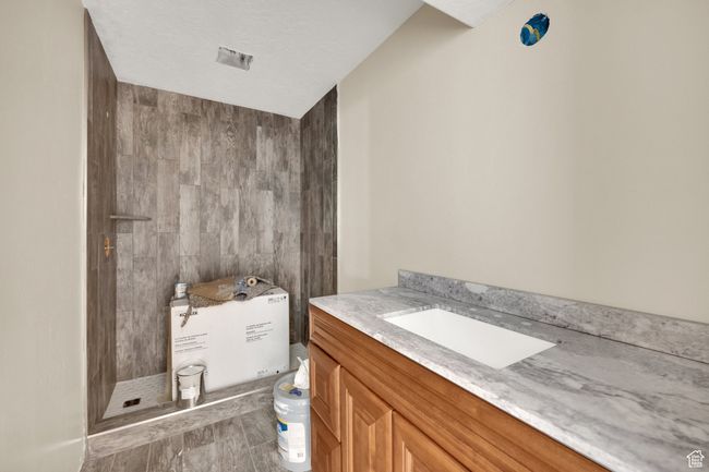 Bathroom featuring a stall shower and vanity | Image 20