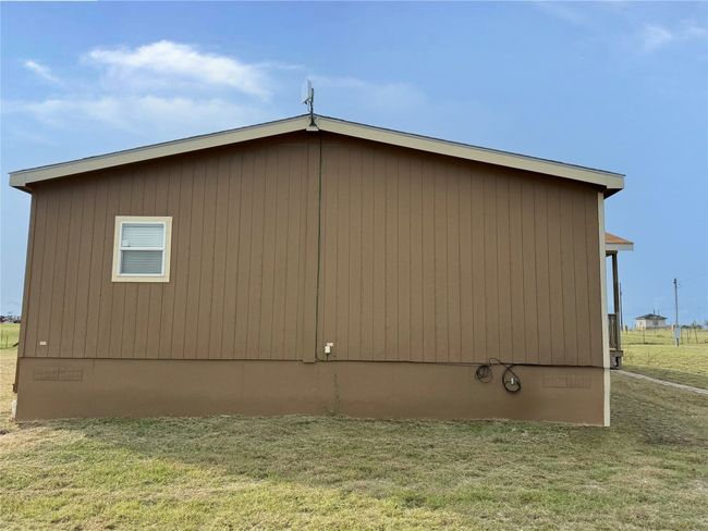 View of home's exterior featuring a lawn and crawl space | Image 27