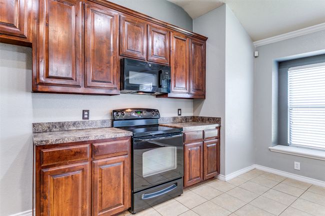 Everything you need, right where you need it, stove, microwave and plenty of counter space to make cooking a breeze. | Image 15