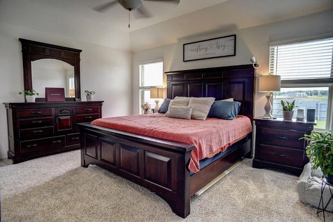 Bedroom with ceiling fan and light carpet | Image 15