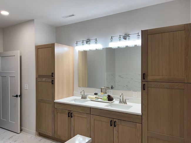 Beautiful primary suite vanity and includes his/her closets, separate toilet room, soaking tub and large walk-in tiled shower | Image 10