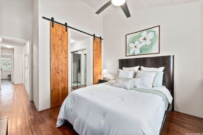 Sliding barn doors smoothly glide open to reveal double closets that lead directly into the primary bathroom. | Image 11