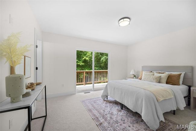Carpeted bedroom featuring access to exterior and baseboards | Image 24