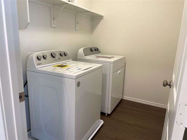 Laundry area with separate washer and dryer, dark wood-style floors, and baseboards | Image 20