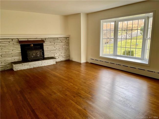 Living room with woodstove insert in fireplace | Image 5