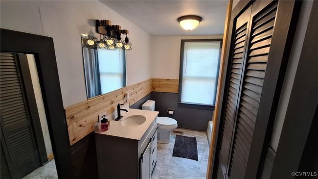 Bathroom featuring vanity, wainscoting, toilet, and a healthy amount of sunlight | Image 21