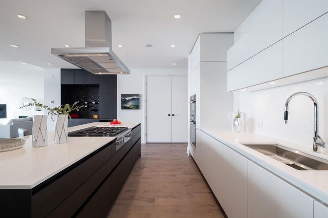 Kitchen with island range hood, modern cabinets, stainless steel gas cooktop, and recessed lighting | Image 16
