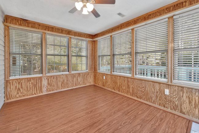 Kitchen featuring light hardwood / wood-style flooring, white cabinets, white appliances, and ornamental molding | Image 6