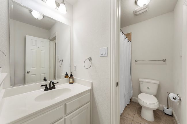 Full bath with vanity, toilet, tile patterned flooring, and baseboards | Image 30