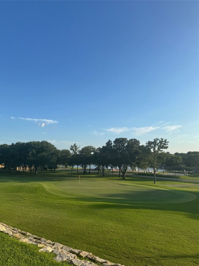 Surrounding community featuring a yard, golf course view, and a putting green | Image 4