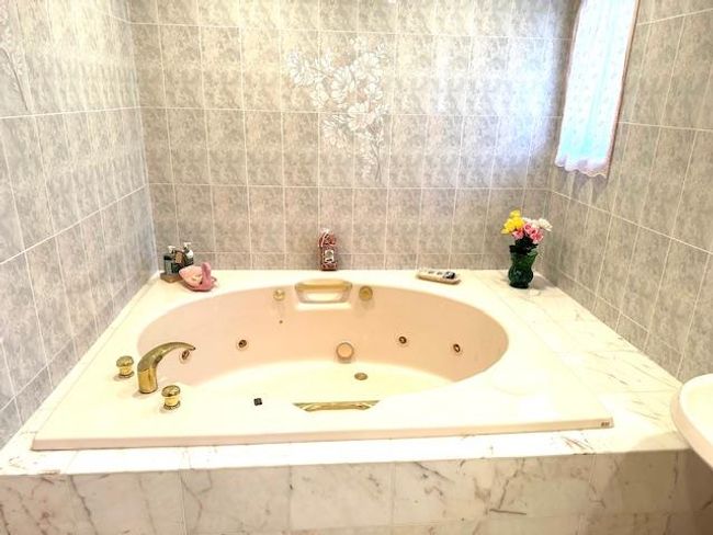 Bathroom featuring tiled bath | Image 10