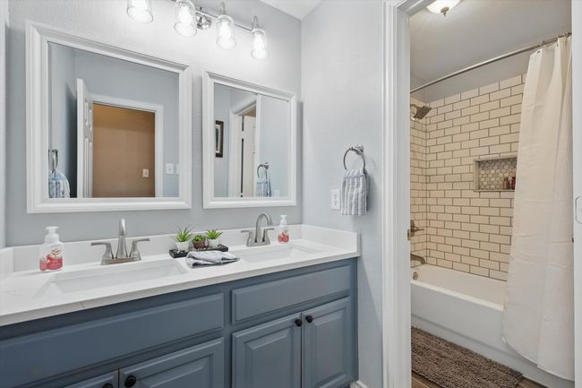 Full bath with shower / tub combo with curtain and double vanity | Image 25