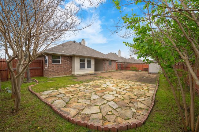Back of house with an outdoor structure, a patio, a fenced backyard, brick siding, and a chimney | Image 23