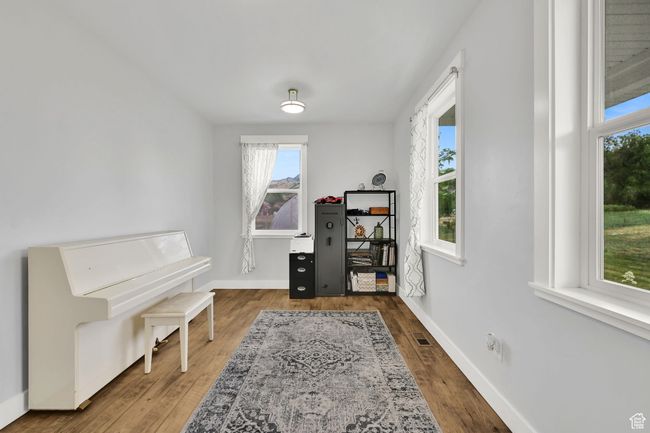 Living area with baseboards and wood finished floors | Image 8