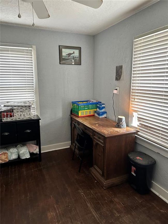 Office space featuring a textured ceiling, baseboards, dark wood-style flooring, and a textured wall | Image 20