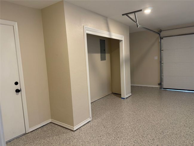 Garage featuring baseboards and electric panel | Image 40