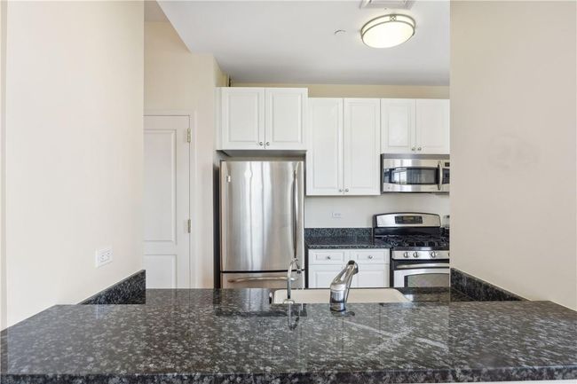 Kitchen with stainless steel appliances and granite counters. | Image 4