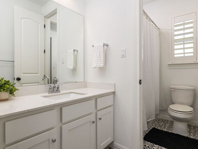 Bathroom featuring toilet, vanity, and baseboards | Image 14