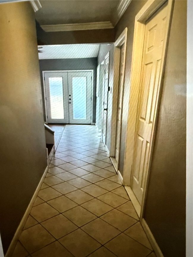 Hallway featuring tile patterned flooring, french doors, and crown molding | Image 5