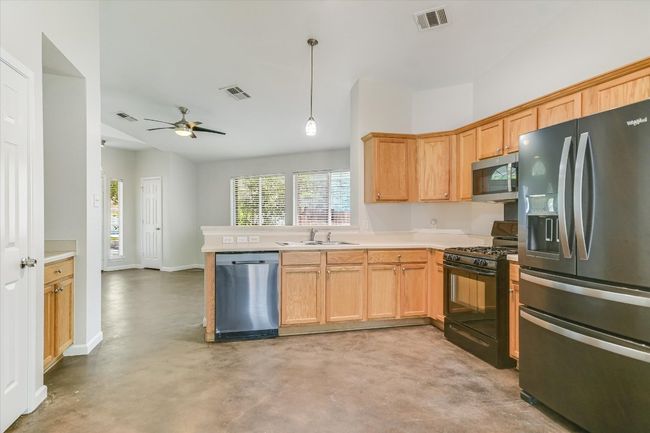 Kitchen features black stainless steel appliances-recent refrigerator, microwave and dishwasher (gas stove is black) | Image 5