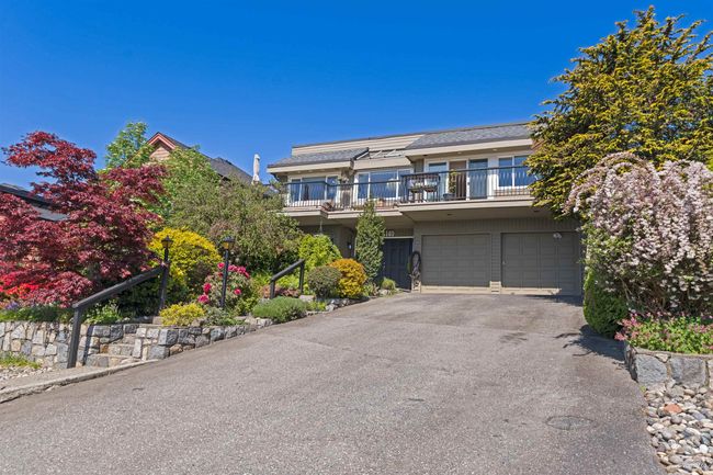 Traditional-style home with a garage and driveway | Image 4