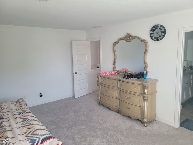 bedroom featuring light colored carpet and ensuite bathroom | Image 10