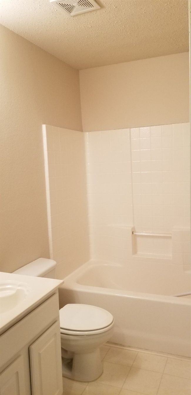 Full bathroom featuring vanity, shower combination, and a textured ceiling | Image 4