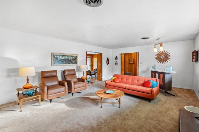 Carpeted living room with baseboards | Image 11