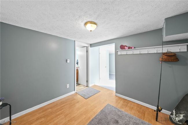 Room featuring hardwood / wood-style flooring and a textured ceiling | Image 24
